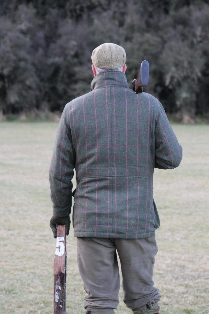 A gamekeeper standing getting ready to hunt
