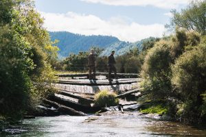 two hunters crossing a bridge